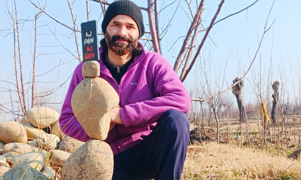 Mudasir Rehman Dar balances stones to promote mindfulness, environmental awareness, and reconnection with nature in the Kashmir Valley.